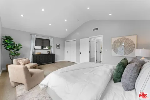 a large white bed in a kitchen