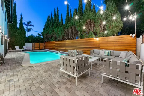 a view of a chairs and table in the patio