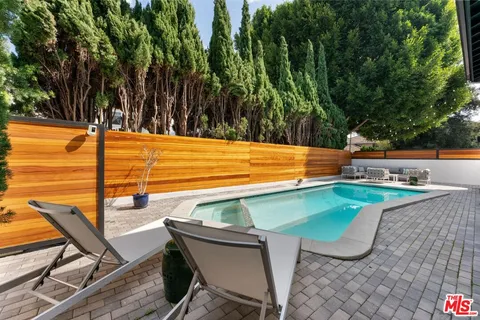 a view of a chairs and table in patio
