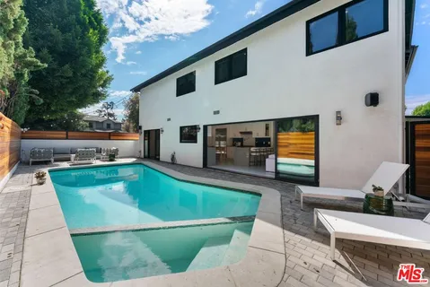 a view of a swimming pool with an outdoor seating