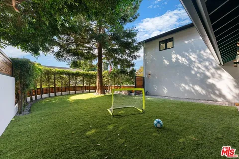 a backyard of apartments with large trees