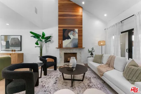 a living room with furniture fireplace and window