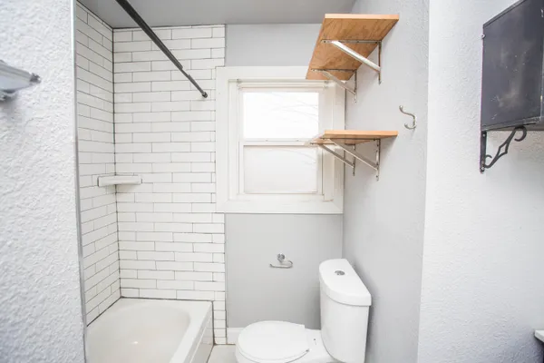 a white toilet sitting next to a bathroom sink