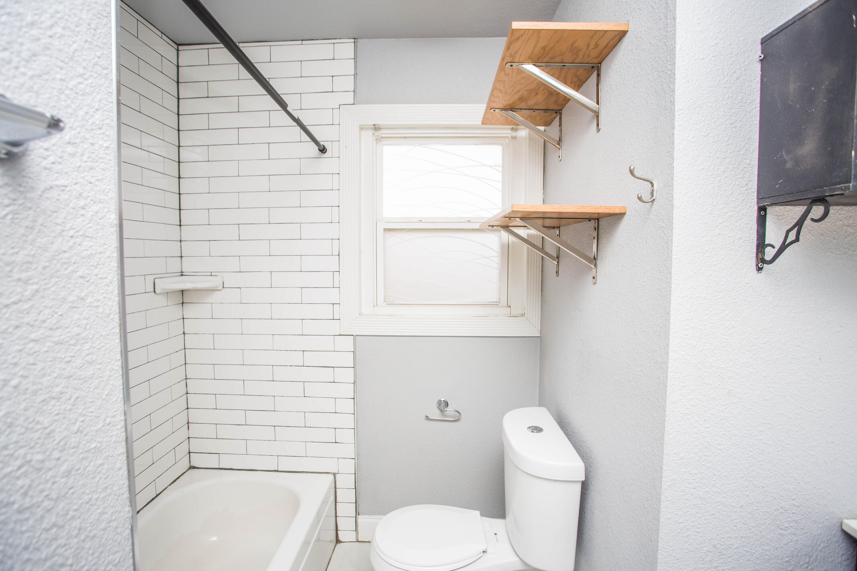 2409 39th Street Lubbock, TX 79412 - Photo 11 of 16 a white toilet sitting next to a bathroom sink