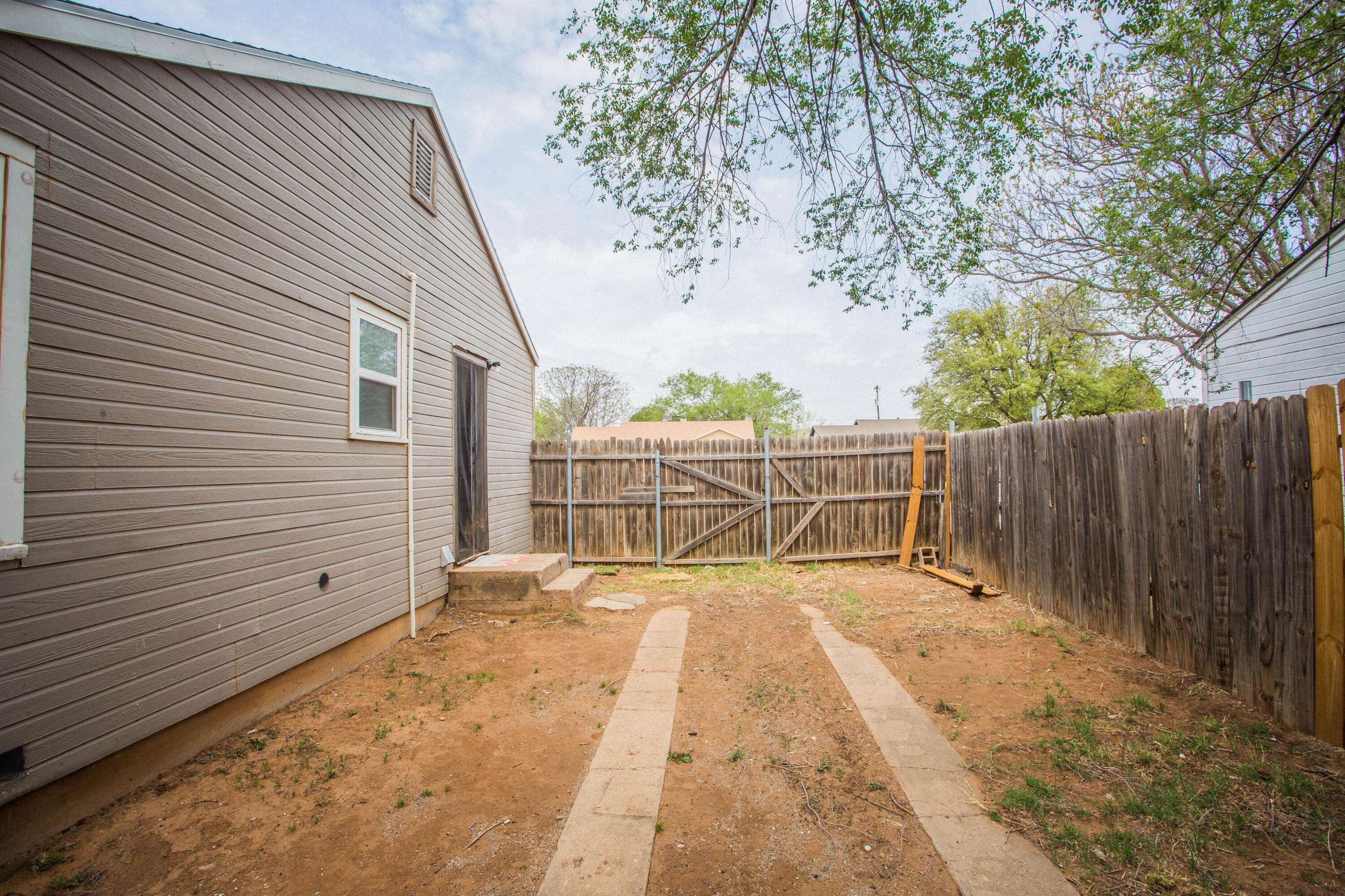 2409 39th Street Lubbock, TX 79412 - Photo 14 of 16 a view of backyard with wooden fence