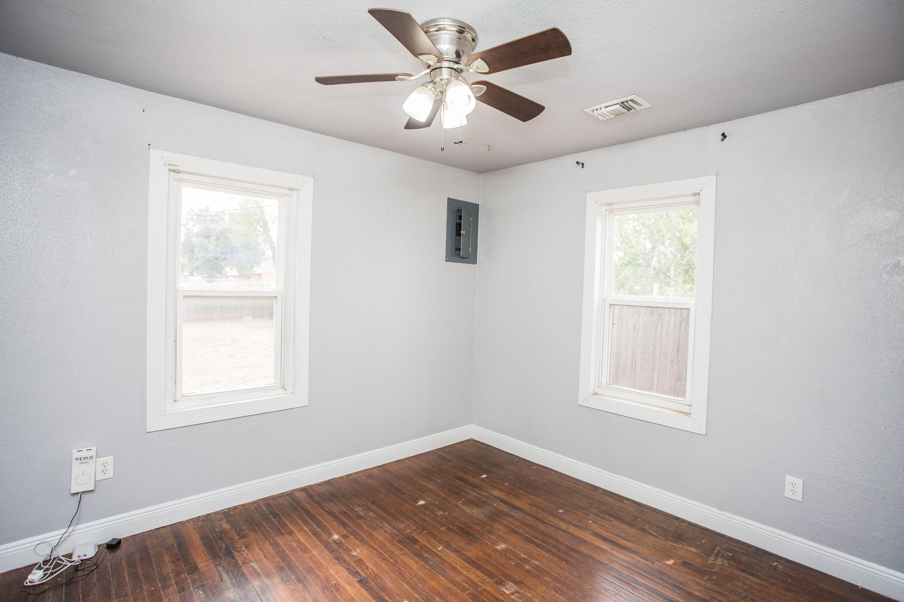 2409 39th Street Lubbock, TX 79412 - Photo 8 of 16 a view of an empty room with a window and wooden floor