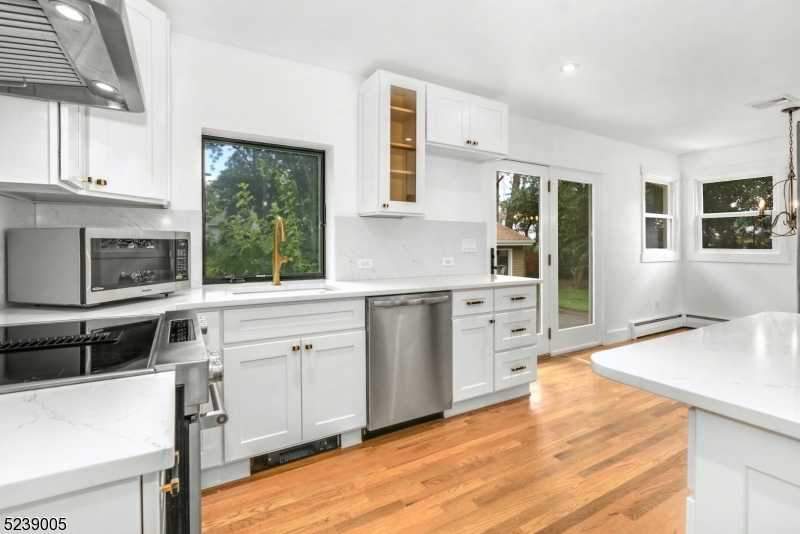 22 Morningside Road Woodbridge, NJ 07067 - Photo 13 of 27 a kitchen with white cabinets and wooden floor
