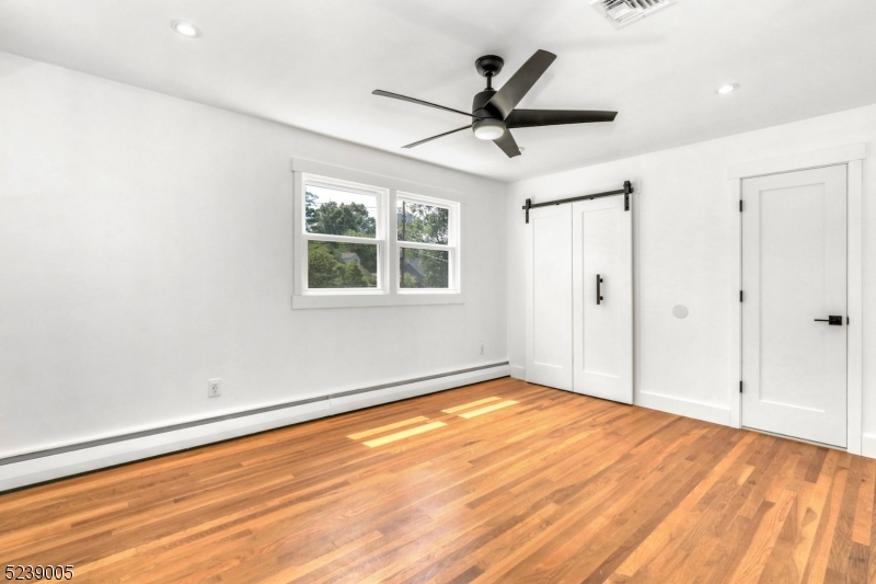22 Morningside Road Woodbridge, NJ 07067 - Photo 19 of 27 a view of a big room with wooden floor and windows in a room