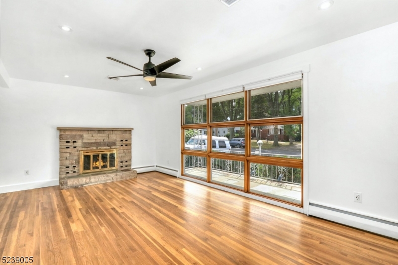 22 Morningside Road Woodbridge, NJ 07067 - Photo 2 of 27 a living room with a fireplace furniture and a floor to ceiling window