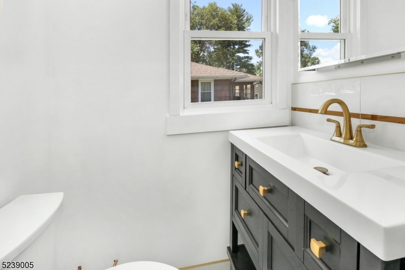 22 Morningside Road Woodbridge, NJ 07067 - Photo 22 of 27 a bathroom with a sink a toilet and a mirror