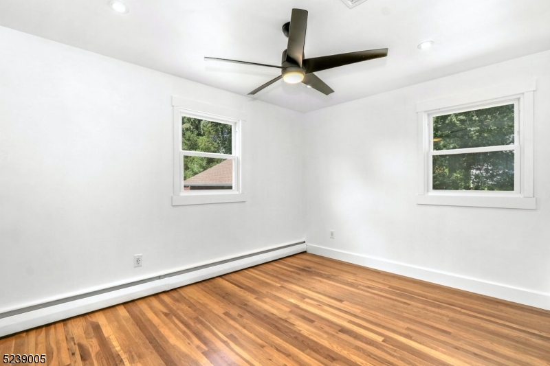 22 Morningside Road Woodbridge, NJ 07067 - Photo 23 of 27 a view of empty room with wooden floor and fan