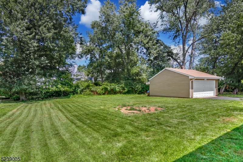 22 Morningside Road Woodbridge, NJ 07067 - Photo 27 of 27 a backyard of a house with plants and large trees