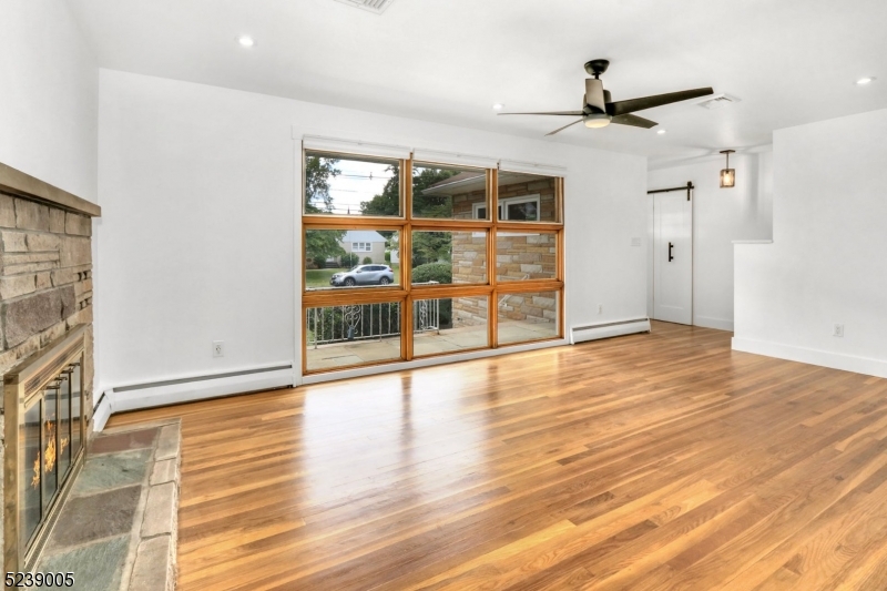 22 Morningside Road Woodbridge, NJ 07067 - Photo 3 of 27 a view of empty room with wooden floor and fan