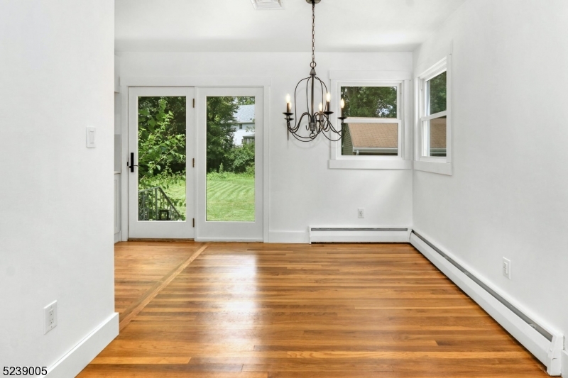 22 Morningside Road Woodbridge, NJ 07067 - Photo 6 of 27 a view of a room with wooden floor chandeliers and kitchen view