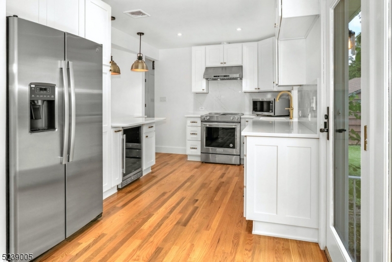 22 Morningside Road Woodbridge, NJ 07067 - Photo 9 of 27 a kitchen with stainless steel appliances a refrigerator sink and stove