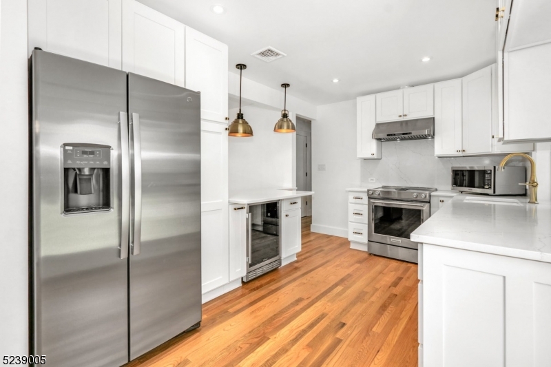 22 Morningside Road Woodbridge, NJ 07067 - Photo 10 of 27 a kitchen with kitchen island a counter top space a sink appliances and cabinets