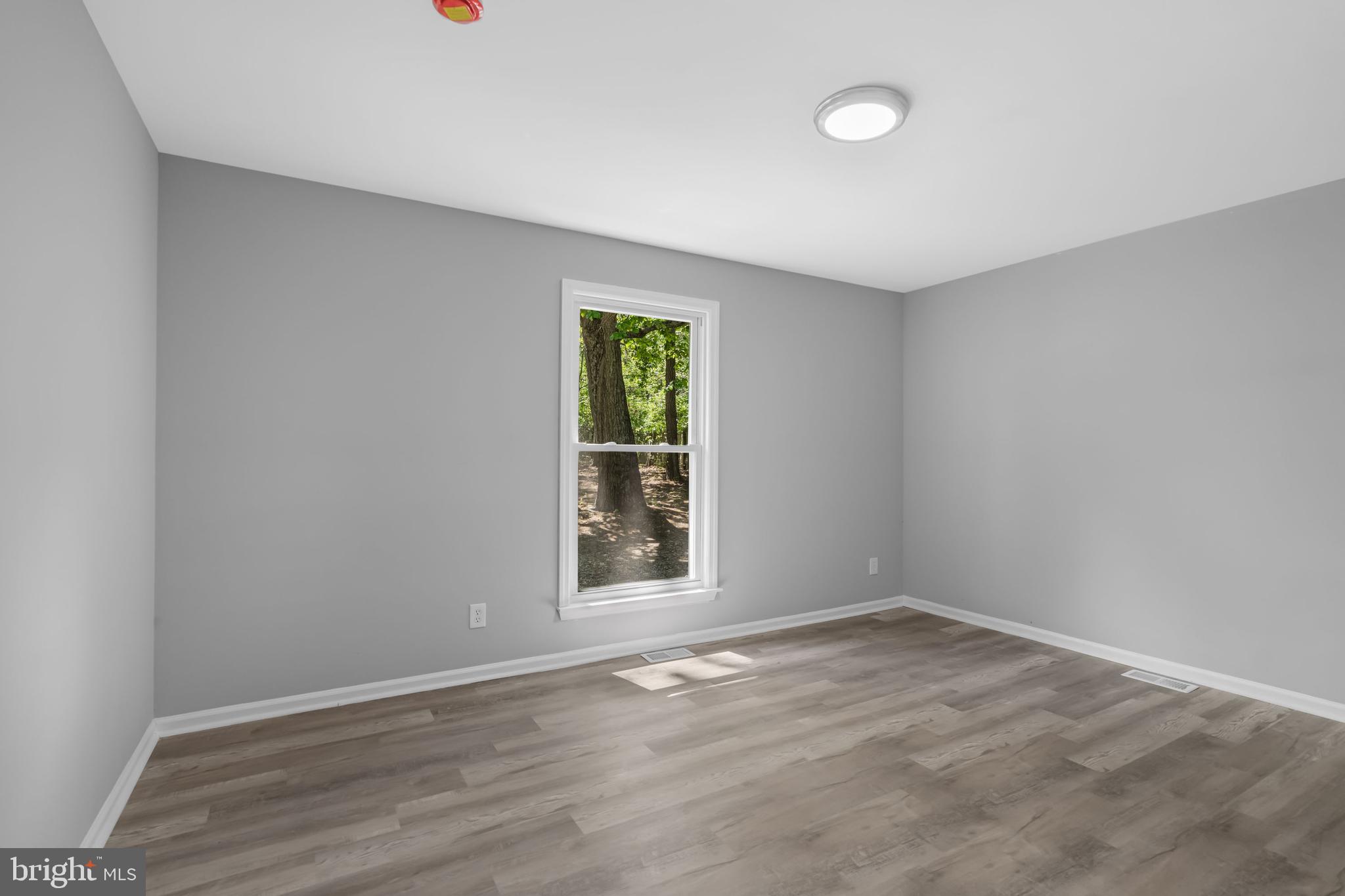 840 Jarvis Road Sicklerville, NJ 08081 - Photo 11 of 25 an empty room with wooden floor and windows