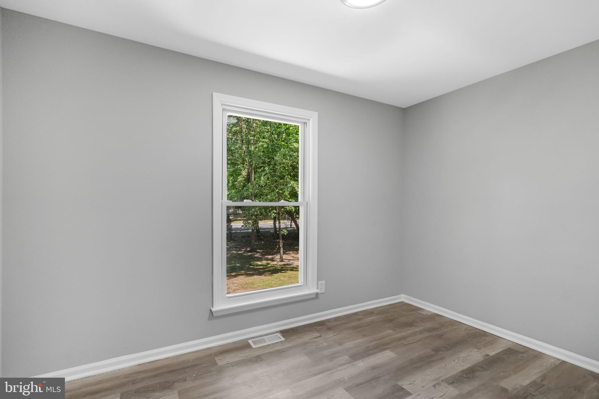 840 Jarvis Road Sicklerville, NJ 08081 - Photo 7 of 25 a view of an empty room with wooden floor and a window