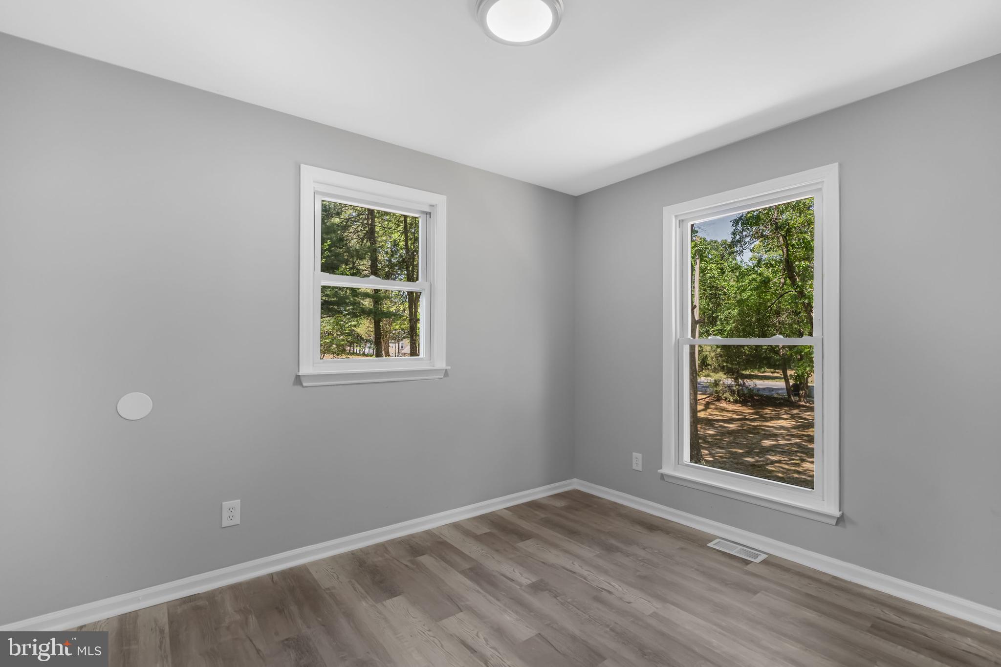 840 Jarvis Road Sicklerville, NJ 08081 - Photo 9 of 25 a view of an empty room with wooden floor and a window