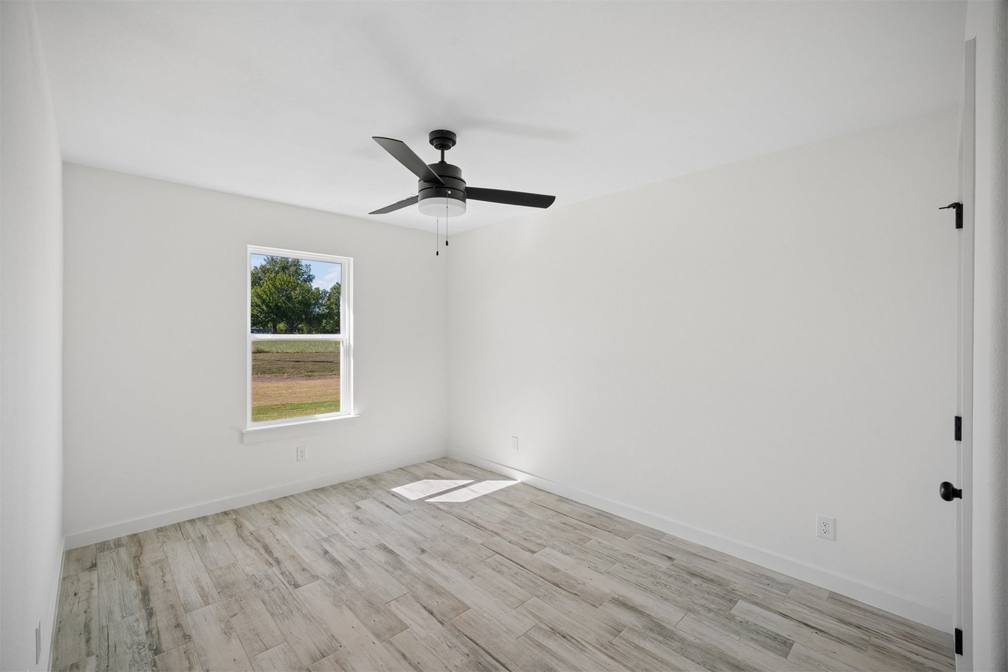25036 South 4205 Road Inola, OK 74036 - Photo 16 of 30 Recessed ceiling, matte black ceiling fan, white window trim, wood-finish flooring, white walls