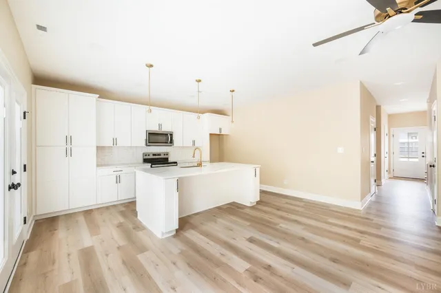 a kitchen with stainless steel appliances white cabinets and a sink