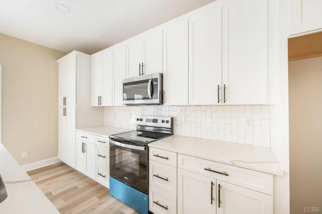 a kitchen with cabinets and white appliances