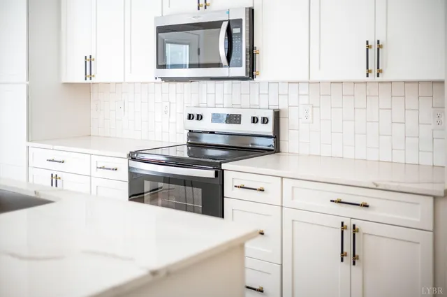 a kitchen with kitchen island a stove a sink and wooden floor