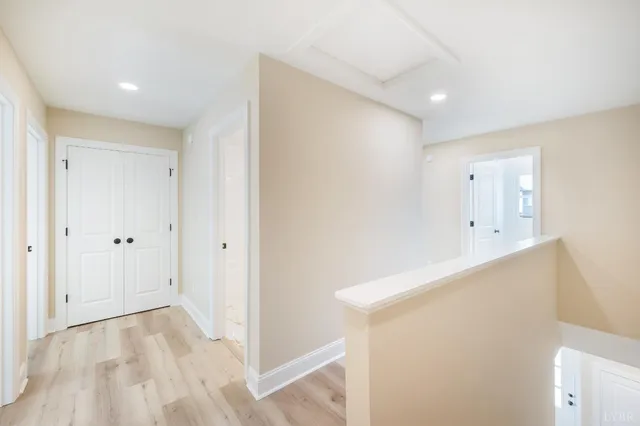 a view of empty room with wooden floor and ceiling fan