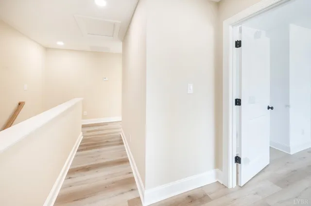 a view of a room with wooden floor