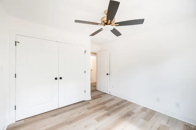 a view of a house with a large window and wooden fence