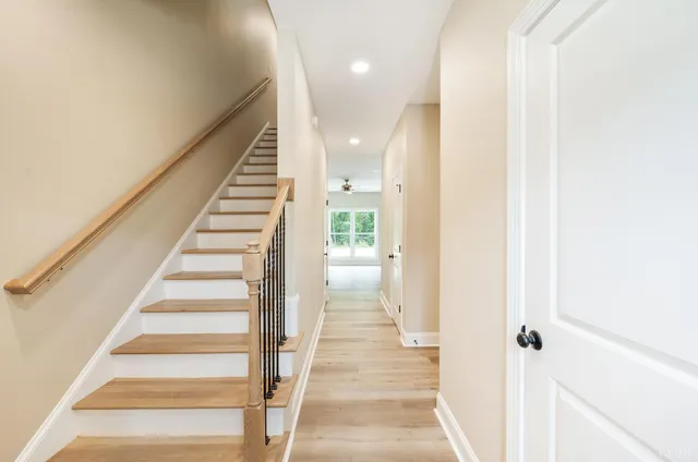 a view of a hallway with wooden floor and entryway