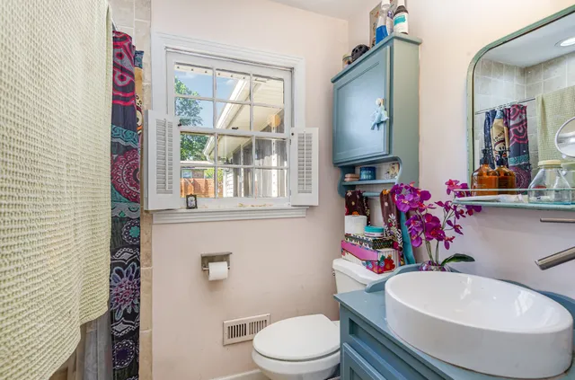 a bathroom with a toilet sink and mirror