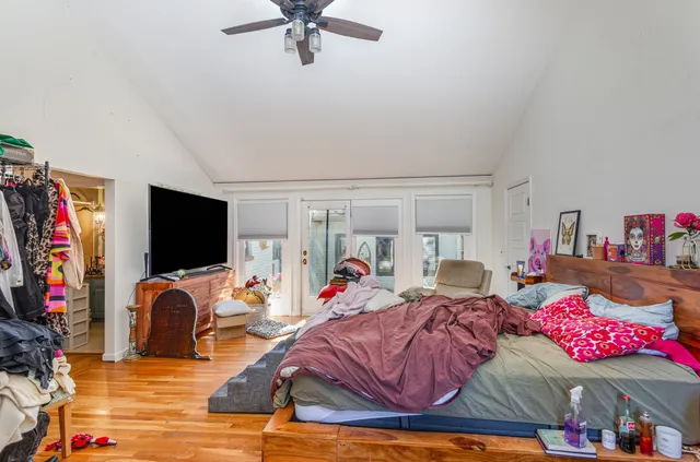 a bedroom with furniture and a flat screen tv