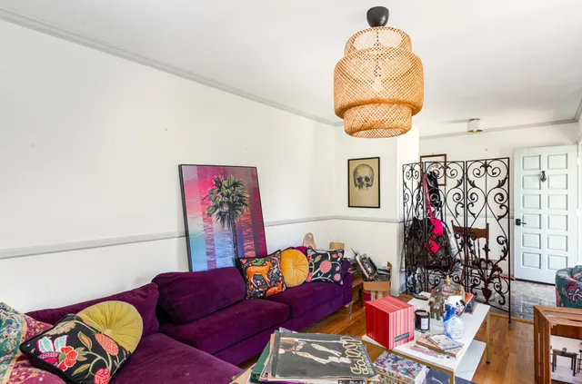 a living room with furniture and a mirror