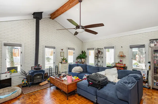 a living room with furniture or couch and a ceiling fan