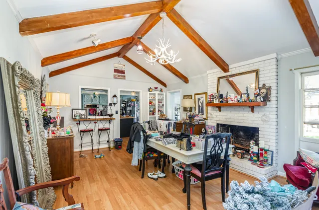 a living room with furniture a fireplace and a large window