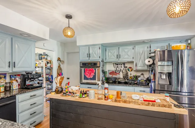 a kitchen with refrigerator and cabinets