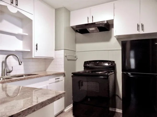 a kitchen with a stove and a refrigerator