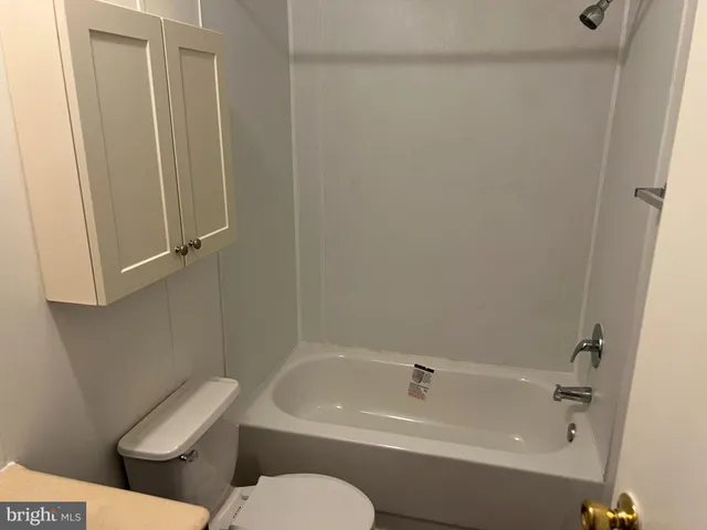 a bathroom with a toilet and bathtub
