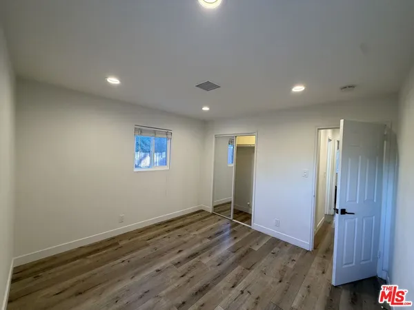 a view of hallway with wooden floor
