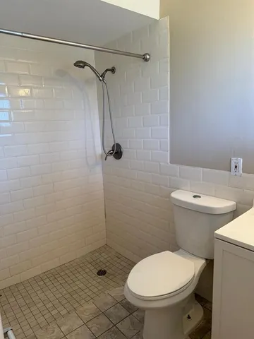 a bathroom with a toilet and a shower