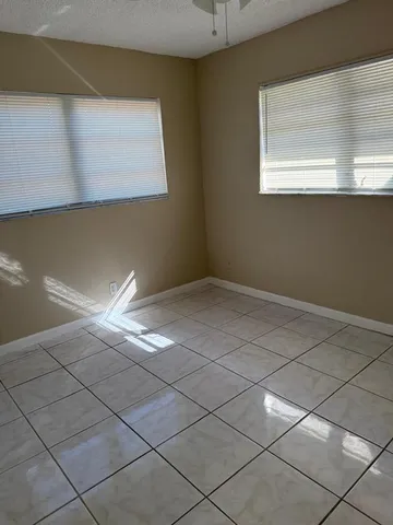 a view of a livingroom with an empty space and a window