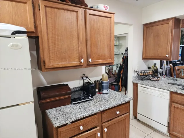 a kitchen with a sink a stove and cabinets
