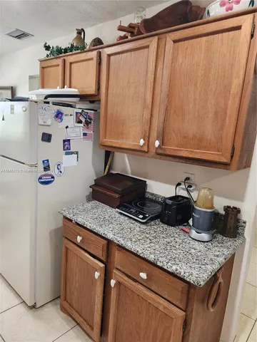 a kitchen with granite countertop a sink a stove and a wooden floor
