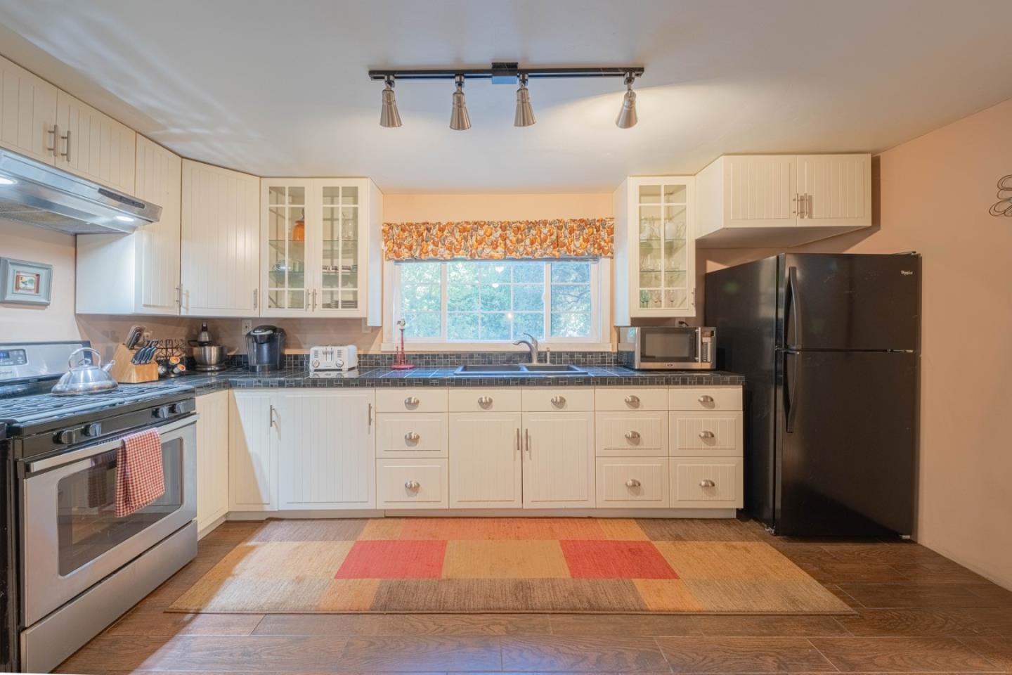 37151 Nason Road Carmel Valley, CA 93924 - Photo 3 of 22 a kitchen with stainless steel appliances granite countertop a refrigerator a stove and a sink