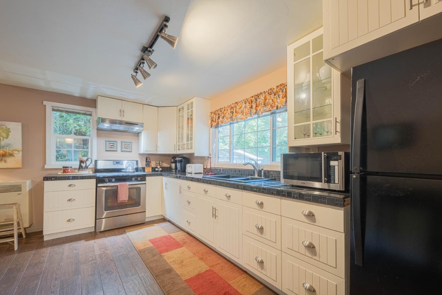 37151 Nason Road Carmel Valley, CA 93924 - Photo 4 of 22 a kitchen with granite countertop white cabinets and stainless steel appliances