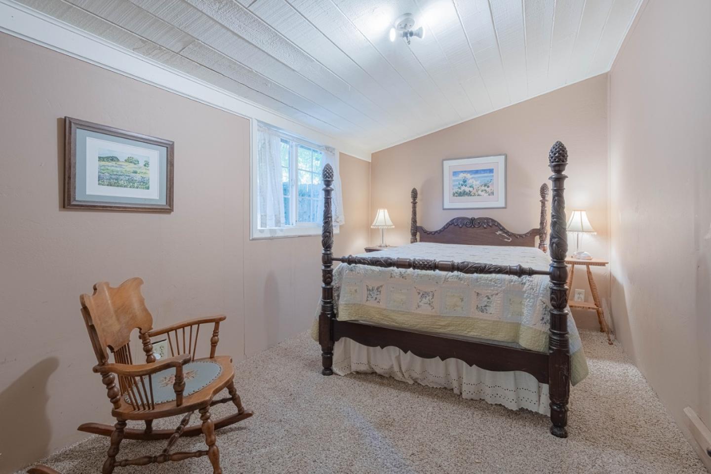 37151 Nason Road Carmel Valley, CA 93924 - Photo 7 of 22 a bedroom with a bed and a chair