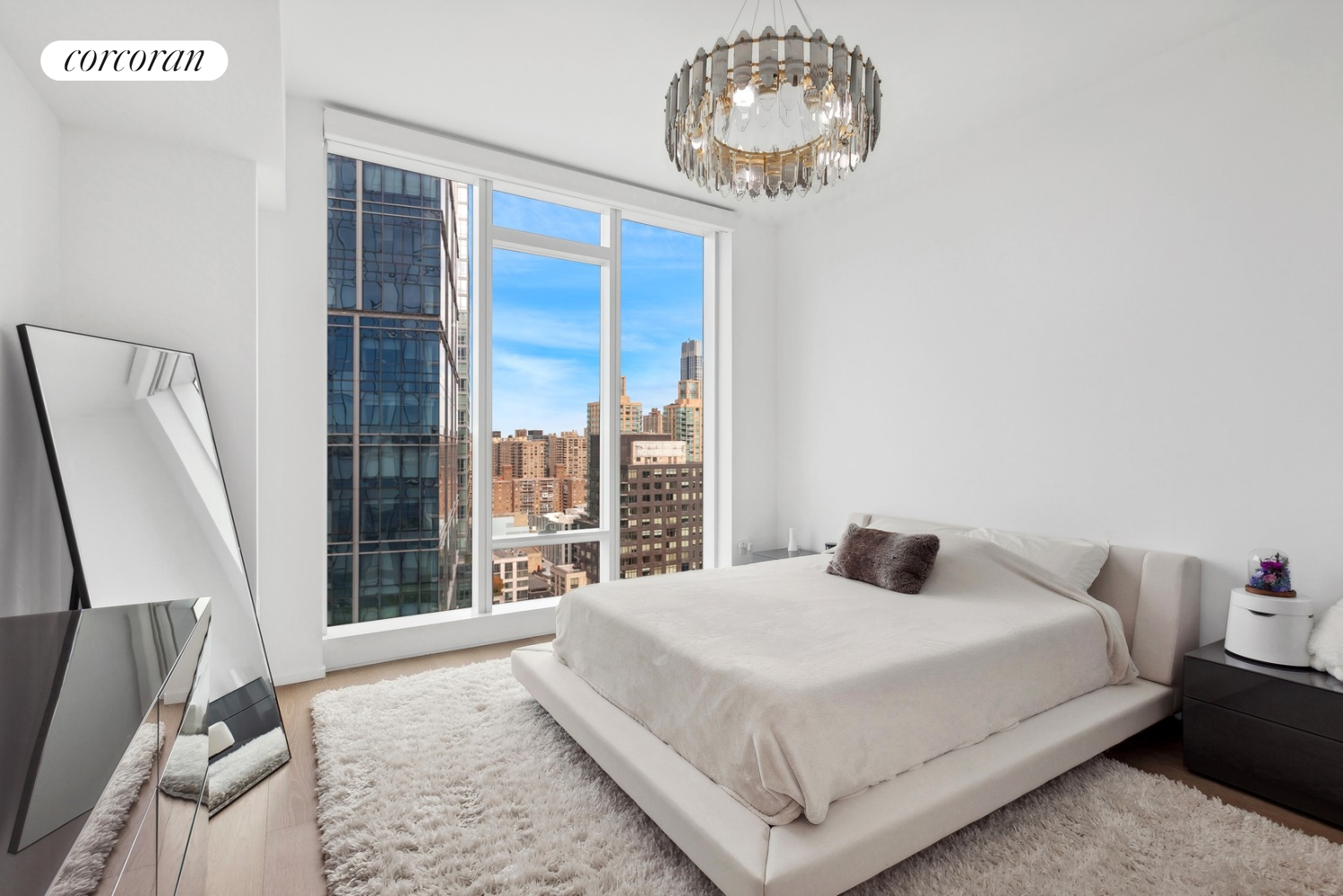 30 Riverside Boulevard, Unit 28C Manhattan, NY 10069 - Photo 5 of 10 a bedroom with a large bed and a large window