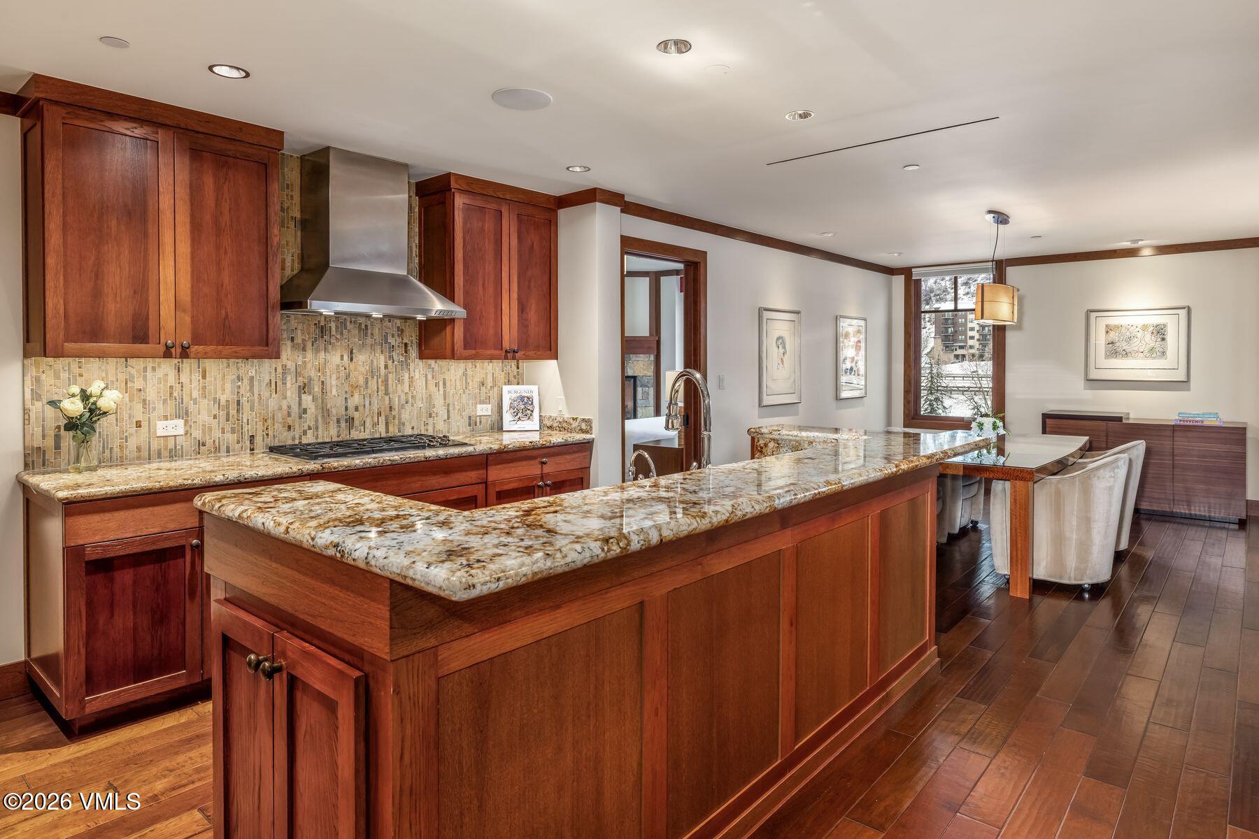1 Vail Road, Unit 9204 Vail, CO 81657 - Photo 8 of 27 a kitchen with granite countertop lots of counter top space and wooden floor