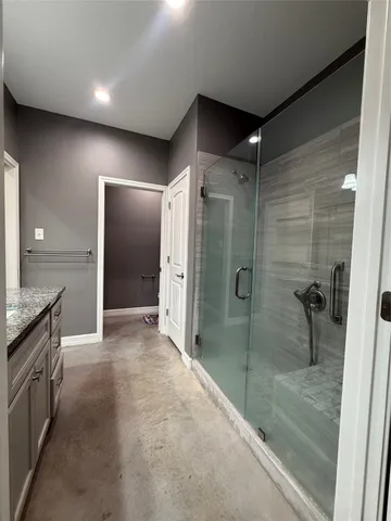 a bathroom with a shower and a sink